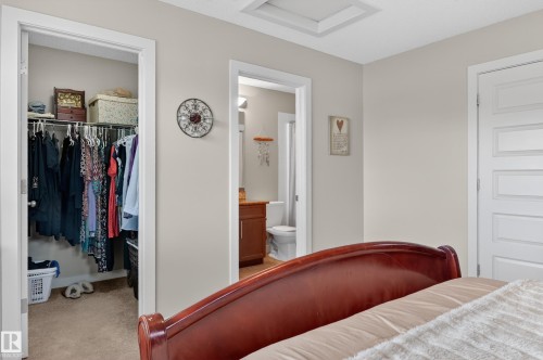 Spacious closet featuring wire shelving system, light beige wall paint, and carpet flooring - 1786 Cunningham Way Sw, Edmonton, AB - Indoor Photo Showing Bedroom