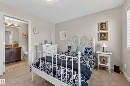 Carpeted bedroom with a window featuring blinds and light-toned walls - 1786 Cunningham Way Sw, Edmonton, AB - Indoor Photo Showing Bedroom