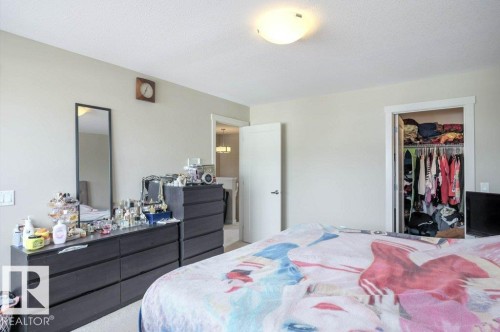 Interior room featuring light neutral wall paint, white trim, and a ceiling-mounted light fixture - 16619 14 Avenue, Edmonton, AB - Indoor Photo Showing Bedroom