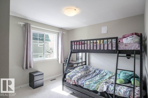 Bedroom featuring light neutral wall paint and a single window with white trim - 16619 14 Avenue, Edmonton, AB - Indoor Photo Showing Bedroom