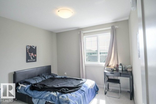 Light-filled room featuring a double-paned window, neutral wall paint, and white trim - 16619 14 Avenue, Edmonton, AB - Indoor Photo Showing Bedroom