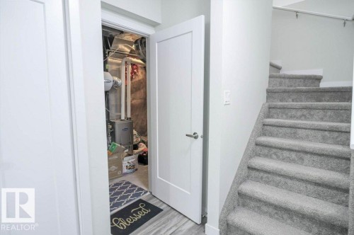 Gray carpeted staircase with white handrail and white wall - 16619 14 Avenue, Edmonton, AB - Indoor Photo Showing Other Room