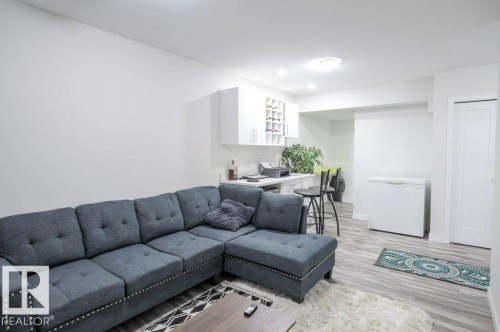 Brightly lit recreation area featuring wood-finish flooring - 16619 14 Avenue, Edmonton, AB - Indoor Photo Showing Living Room