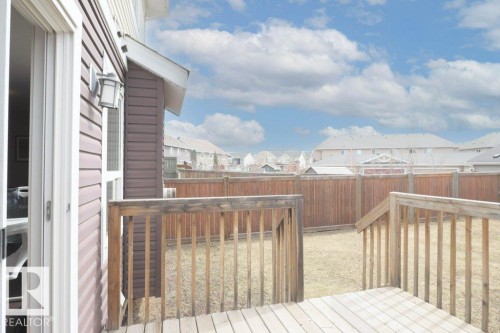Backyard featuring a wood-plank deck with railing, stairs, and a wooden privacy fence - 16619 14 Avenue, Edmonton, AB - Outdoor With Deck Patio Veranda With Exterior