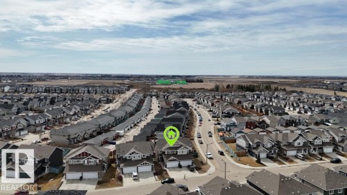 Residential neighborhood featuring detached homes with attached garages, paved streets, and a mix of exterior finishes - 16619 14 Avenue, Edmonton, AB - Outdoor With View