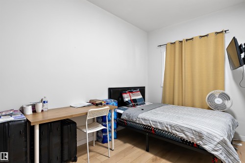 Room featuring light wood-finish flooring and white walls - 11919 96 Street, Edmonton, AB - Indoor Photo Showing Bedroom