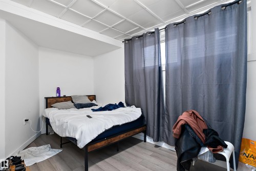 Room with white walls, light wood-finish flooring, and a drop ceiling - 11919 96 Street, Edmonton, AB - Indoor Photo Showing Bedroom