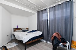 Room with white walls, light wood-finish flooring, and a drop ceiling - 
