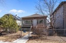Single-story property with brown siding, a front porch with white railing, and a chain-link fence - 11919 96 Street, Edmonton, AB  - Outdoor With Deck Patio Veranda 