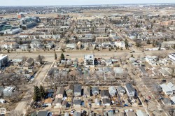 Urban landscape featuring residential properties and commercial buildings with clear street infrastructure - 