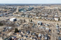 Aerial perspective showcasing an urban landscape with a mix of residential and commercial structures - 