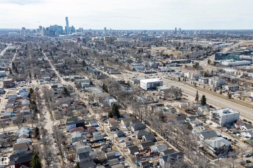 Aerial perspective showcasing a residential neighborhood with a distant cityscape - 11919 96 Street, Edmonton, AB - Outdoor With View