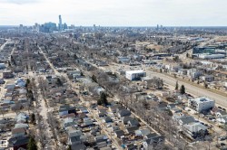 Aerial perspective showcasing a residential neighborhood with a distant cityscape - 