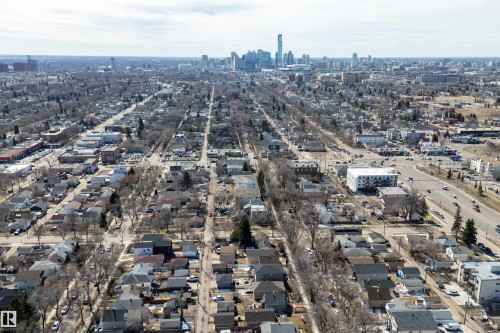Aerial perspective showcasing a residential neighborhood with a distant urban skyline - 11919 96 Street, Edmonton, AB - Outdoor With View