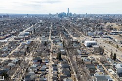 Aerial perspective showcasing a residential neighborhood with a distant urban skyline - 