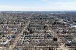 Expansive aerial perspective showcasing a residential area with numerous detached properties - 