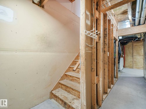 The property features an unfinished area with exposed wooden framing and partial drywall, offering potential for customization - 14 15128 22 Street, Edmonton, AB - Indoor Photo Showing Other Room