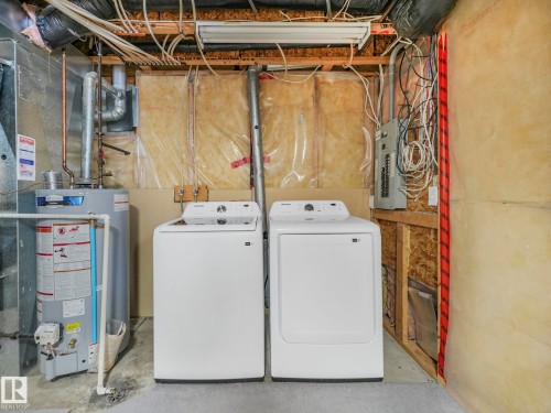 The utility area includes a washer and dryer, a water heater, and an electrical panel - 14 15128 22 Street, Edmonton, AB - Indoor