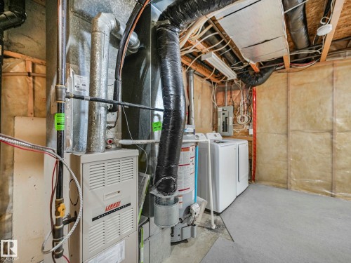 The property includes a utility area with a Lennox furnace, a water heater, and laundry appliances - 14 15128 22 Street, Edmonton, AB - Indoor Photo Showing Basement