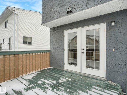 The property features a balcony with a dark green deck and a privacy screen - 14 15128 22 Street, Edmonton, AB - Outdoor With Exterior