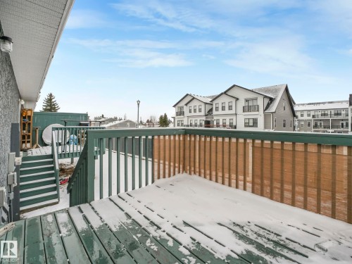 This property features a deck with a railing and steps, offering outdoor space - 14 15128 22 Street, Edmonton, AB - Outdoor