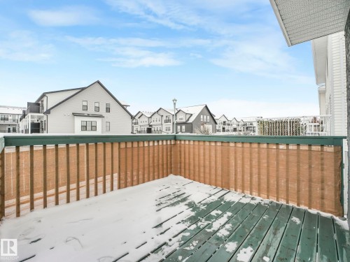 The property features a private deck with a wooden railing and a privacy screen - 14 15128 22 Street, Edmonton, AB - Outdoor With Deck Patio Veranda