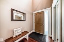 Entryway featuring hardwood floors, a brown door with a frosted sidelight, and a built-in closet with mirrored doors - 3220 151 Avenue, Edmonton, AB  - Indoor Photo Showing Other Room 