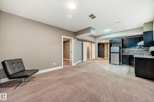 Spacious room featuring neutral-toned walls, recessed lighting, and soft carpeting - 3220 151 Avenue, Edmonton, AB - Indoor