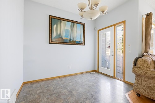 Double French doors with decorative glass panels - 9904 144 Avenue, Edmonton, AB - Indoor Photo Showing Other Room