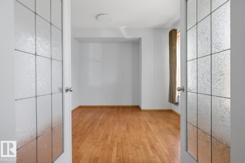 Entryway featuring two frosted glass panel doors - 9904 144 Avenue, Edmonton, AB - Indoor Photo Showing Other Room