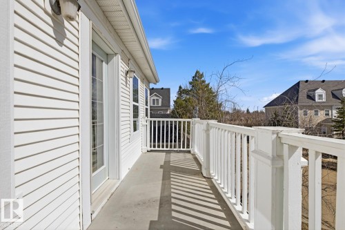 Outdoor balcony featuring white siding, a white railing, and concrete flooring - 9904 144 Avenue, Edmonton, AB - Outdoor