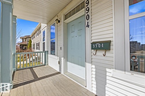 Covered front porch with wood-finish flooring - 9904 144 Avenue, Edmonton, AB - Outdoor With Exterior