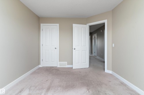 Neutral-toned walls complement the light carpet flooring - 3314 9 Street Nw, Edmonton, AB - Indoor Photo Showing Other Room
