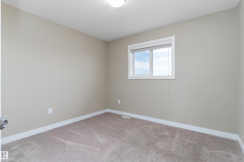 Neutral-toned walls complement plush carpeting - 3314 9 Street Nw, Edmonton, AB - Indoor Photo Showing Other Room