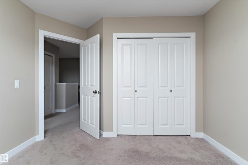 Neutral-toned room featuring a soft carpeted floor and white baseboards - 3314 9 Street Nw, Edmonton, AB - Indoor