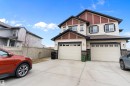 Two-story dwelling featuring a two-car attached garage, light-colored siding, and dark trim accents - 3314 9 Street Nw, Edmonton, AB  - Outdoor 