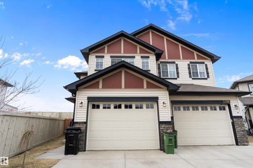 Two-story residence featuring light-colored siding with dark trim accents - 3314 9 Street Nw, Edmonton, AB - Outdoor