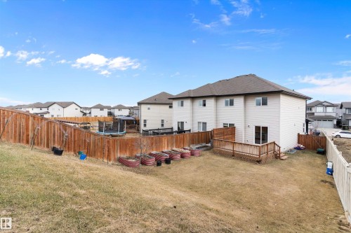 Expansive backyard featuring a wood deck, full privacy fencing, and raised garden beds - 3314 9 Street Nw, Edmonton, AB - Outdoor