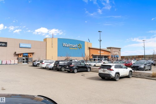 Retail complex featuring a Walmart Supercentre and Pharmacy entrance - 3314 9 Street Nw, Edmonton, AB - Outdoor