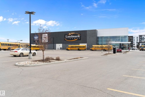 Large commercial building with a black and white facade, featuring prominent signage - 3314 9 Street Nw, Edmonton, AB - Outdoor