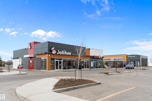 Modern commercial building featuring multiple tenant spaces, contemporary exterior finishes, and ample on-site parking - 3314 9 Street Nw, Edmonton, AB - Outdoor