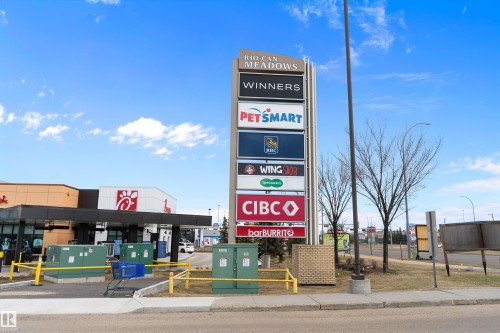 Retail complex pylon sign featuring multiple tenant logos, including Winners, PetSmart, RBC, Wingstop, Specsavers, CIBC, and barBURRITO - 3314 9 Street Nw, Edmonton, AB - Outdoor
