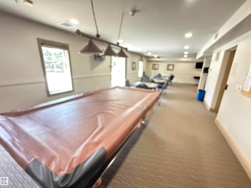 Recreational space featuring a covered billiard table, recessed lighting, and windows providing natural light - 438 1406 Hodgson Way, Edmonton, AB - Indoor Photo Showing Other Room