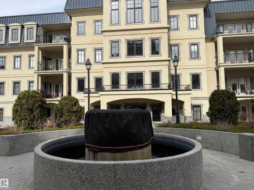 This property features a grand architectural style with multiple balconies, dormer windows, and a prominent entry - 438 1406 Hodgson Way, Edmonton, AB - Outdoor With Balcony With Facade