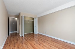 Spacious bedroom featuring neutral-toned walls, and a large bi-fold closet with interior shelving - 