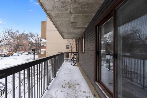 Private balcony featuring metal railings and a concrete ceiling - 206 9929 113 Street, Edmonton, AB - Outdoor With Balcony With Exterior