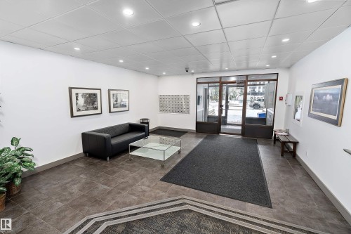 Lobby entrance featuring large format tile flooring, recessed lighting, and a glass-paneled entry door - 206 9929 113 Street, Edmonton, AB - Indoor Photo Showing Other Room