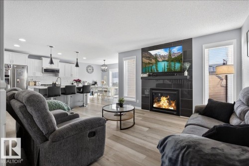 55 Silverstone Drive, Stony Plain, AB - Indoor Photo Showing Living Room With Fireplace
