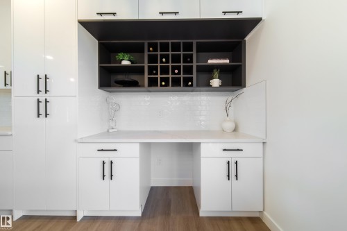 Bar featuring white cabinets, backsplash, and dark wood finished floors - 33 Sun Meadows Cl, Stony Plain, AB - Indoor
