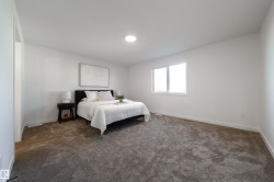 Carpeted bedroom with baseboards - 